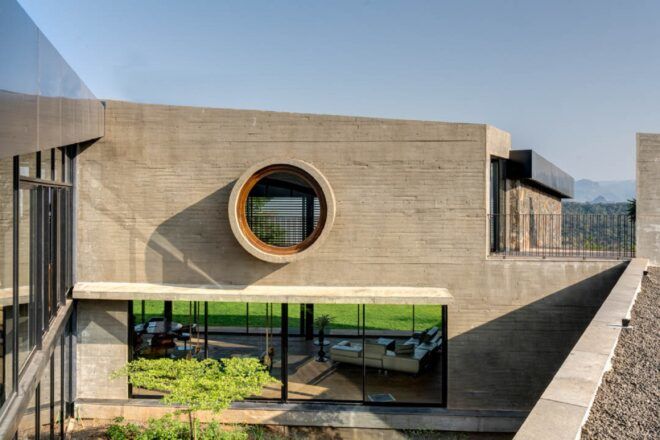 A rectangular-shaped home with a circular window