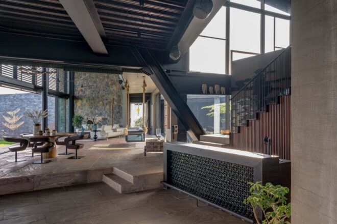 An open area that has a divide between two room by stairs leading to a living room area