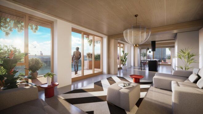 The inside of the living room of an apartment where a man is standing outside on the balcony
