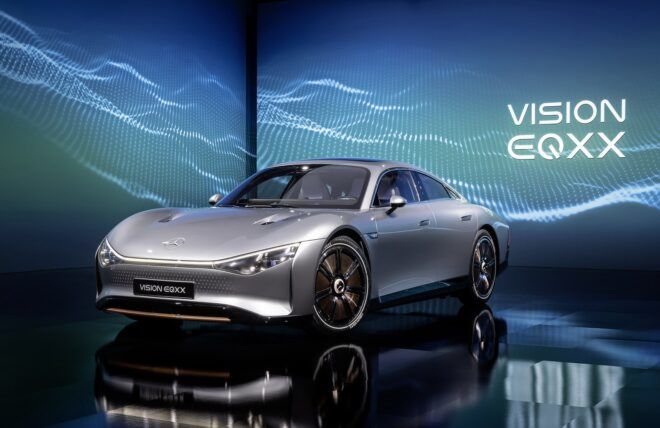 A sleek grey Mercedes-Benz sits in front of a sign that reads VISION EQXX