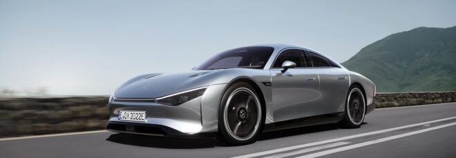 A sleek silver electric vehicle driving down a highway