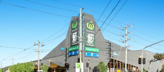 A large industrial complex at the corner of a city intersection