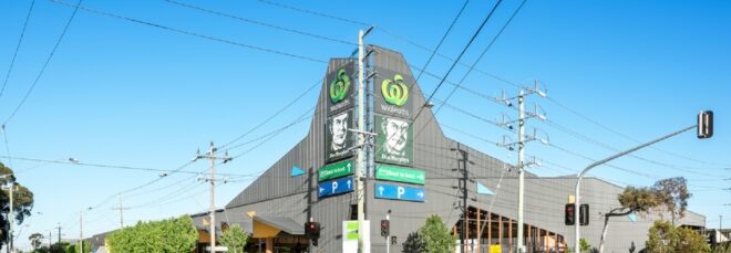 A large industrial complex at the corner of a city intersection