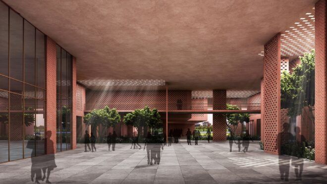 A large open hallway of the university with shadowy people standing sporadically throughout it