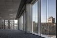 An open plan office interior surrounded by glass walls.