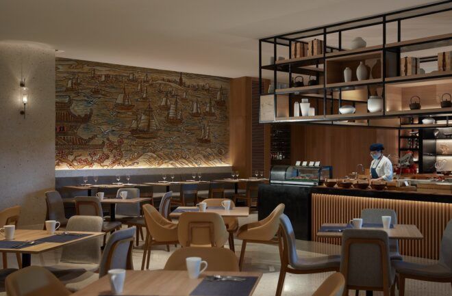 A dining area that has a mural on the backwall that is inspired by Ancient China
