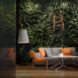A wall filled with plants and the the letter B enmeshed in it