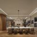 A long table with chairs tucked on either side of it and an artistic chandelier hanging above it