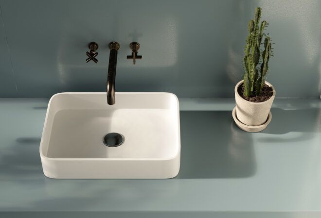 A blue bathroom with white sink.