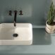 A blue bathroom with white sink.