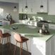 A kitchen in muted green tones.