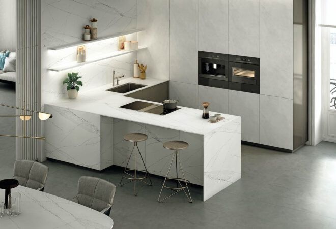 A kitchen with white marble features.