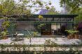 Modern apartment surrounded by greenery.