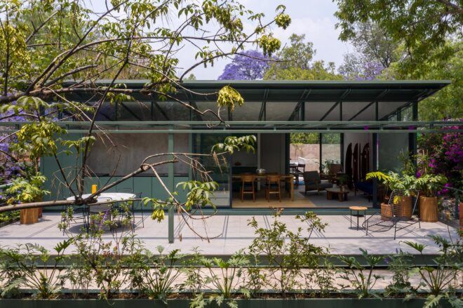 Modern apartment surrounded by greenery.