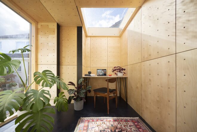 Interior of the dwelling unit is built of wood and has skylight ceiling squares to filter in natural light