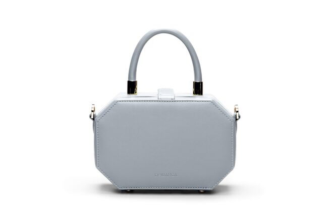 A light blue handbag set against a white background