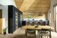 A kitchen with wood ceilings, floors and table.