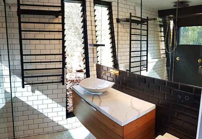 A bathroom with white and black features.