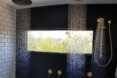 A shower with two rain-style shower heads.