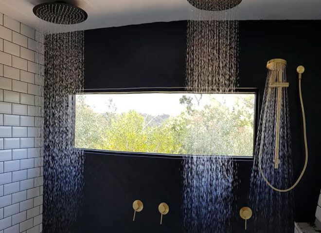 A shower with two rain-style shower heads.