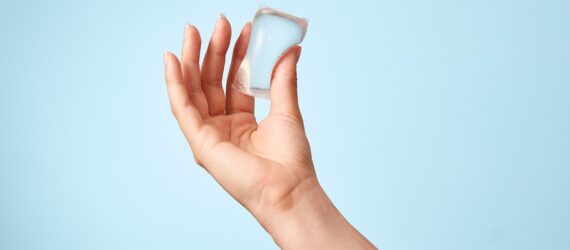 A hand holding a clear Notpla packet
