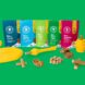 Bags of dog treats and toys, from left to right, dark blue, light blue, light green, dark green and red bags