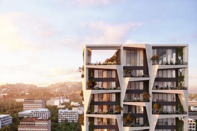 An apartments complex that rises above the city line during sunset