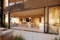 A large outdoor area with an open doorway that has chairs and tables within