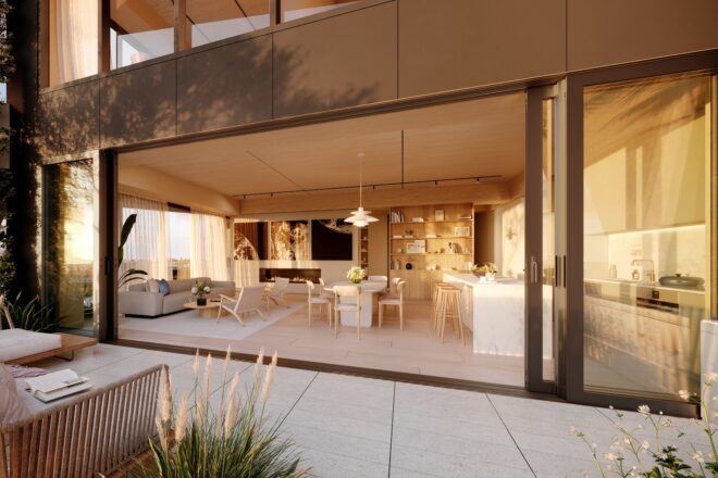 A large outdoor area with an open doorway that has chairs and tables within