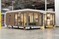 A one-story house sitting in a warehouse