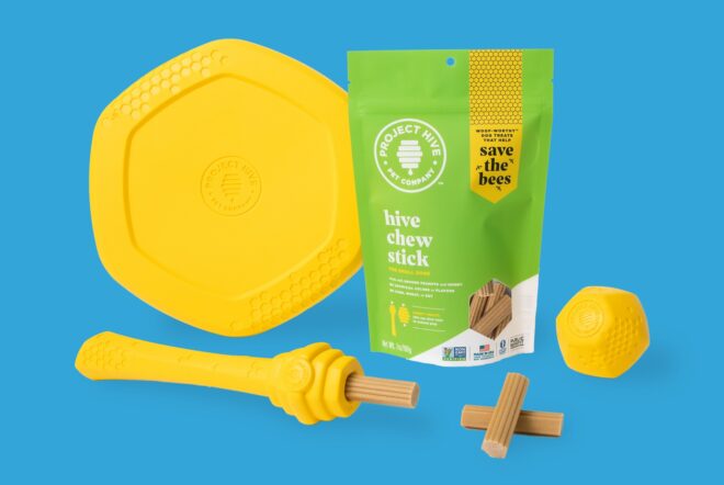A light green bag with dog treats scattered around it on a blue background