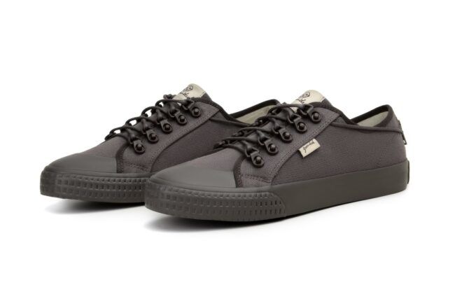 A pair of low-cut black shoes with against a white background