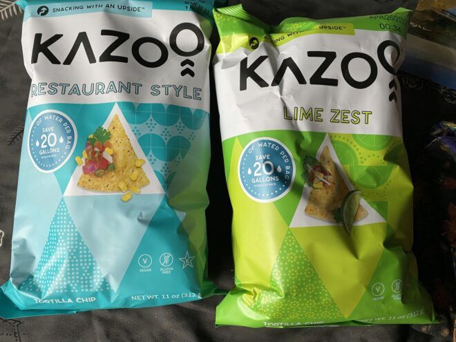 Two chip bags, one blue and one green, with the word Kazoo on them
