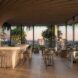 An indoor dining area with windows all around