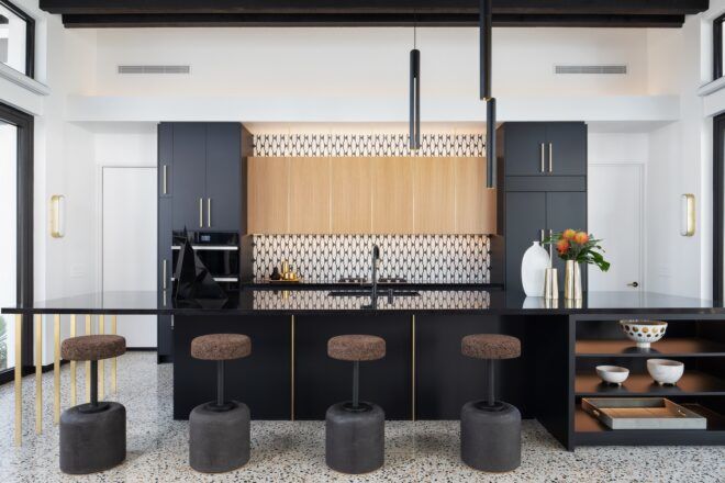 A modern room with a center island and high stools