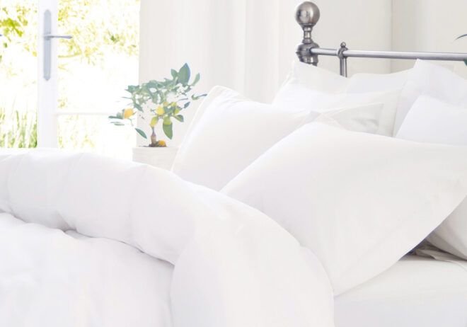 White linens on a bed.