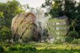 Two structures filled with greenery from top to bottom in a rainforest landscape