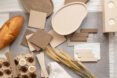 Decorative assortment of eggshell tiles and objects in neutral colors, ranging from light cream shades to deeper browns