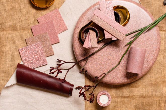Decorative assortment of eggshell tiles and objects in pink hues