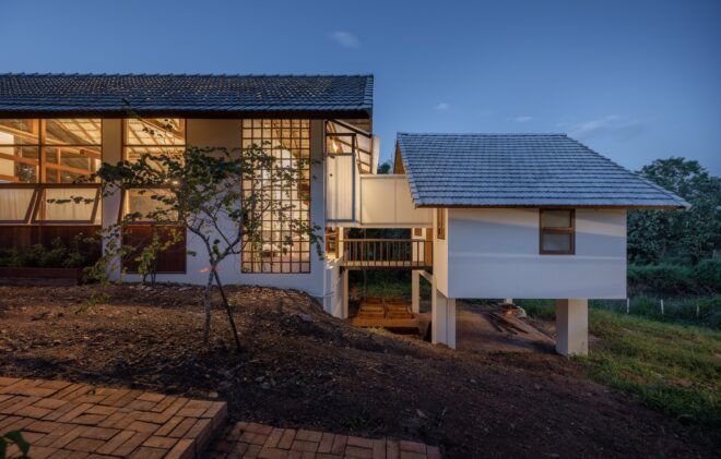 The outside of the home and studio has white walls and plenty of windows