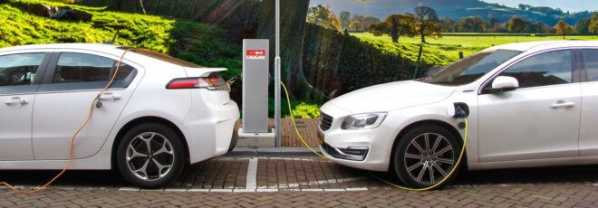 Two white electric cars being charged.