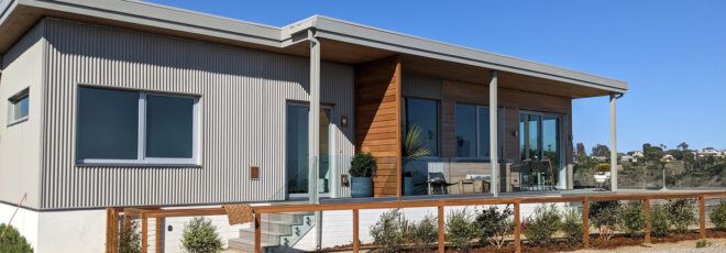 The exterior of a single-level home in a desert-like environment.