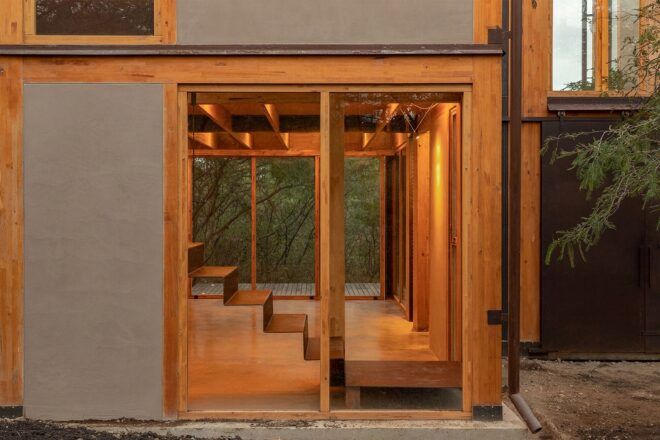 A rectangle wooden doorway with a staircase going upwards
