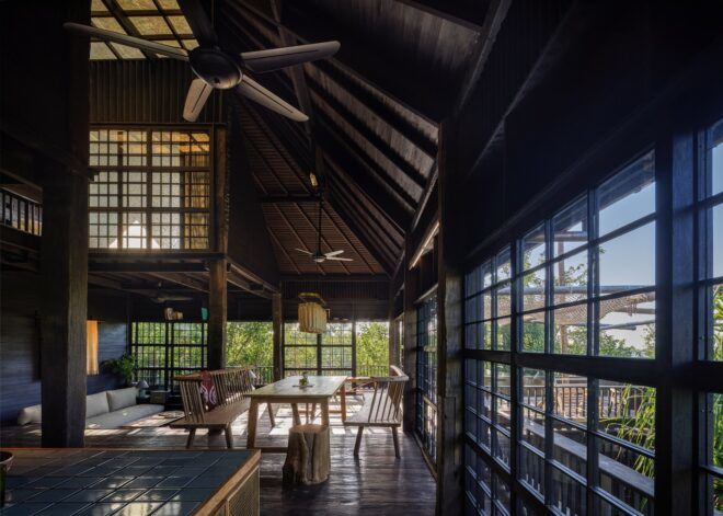 The inside living room area has a ceiling fan and wooden lattice windows