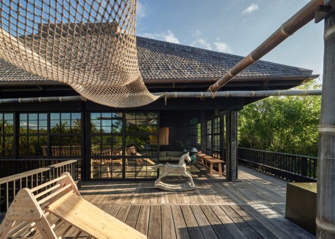 The third floor outside balcony has a net strung over the top and a pole that extends past the photo