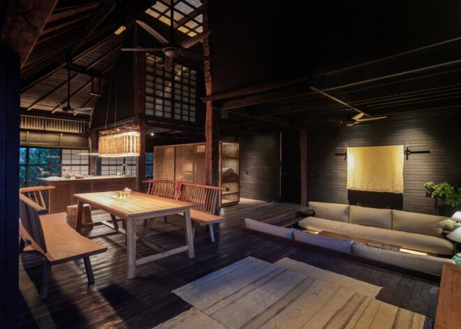 A dining room area with a a rectangle table with benches on either side of it