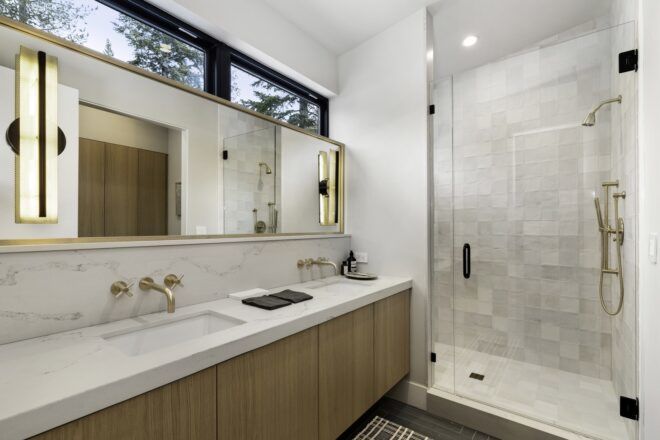 A bathroom with a large sink counter and a standing shower