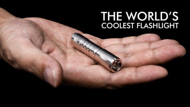 An open palm holding a small three in one tool with the words "The worlds coolest flashlight" in the corner