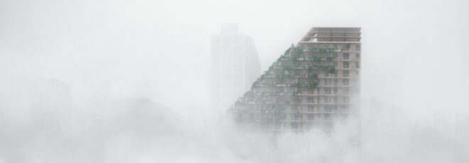 The slanted building emerges from a scene of fog