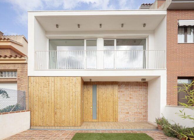The exterior of a brick home with a yard.